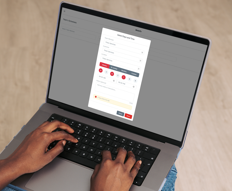 Hands holding tablet showing weekly calendar schedule